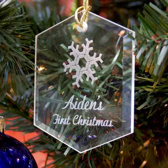 Custom Hexagon Glass Ornament Engraved With Snowflake Art And Aiden’s First Christmas Text Hanging On A Christmas Tree