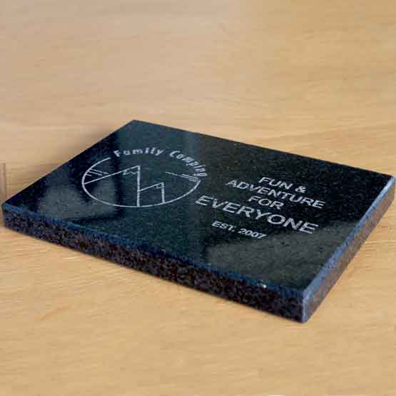 Custom Granite Paperweight Laser Engraved With Family Camping Logo And Date And Fun For Everyone Text On A Wood Desk