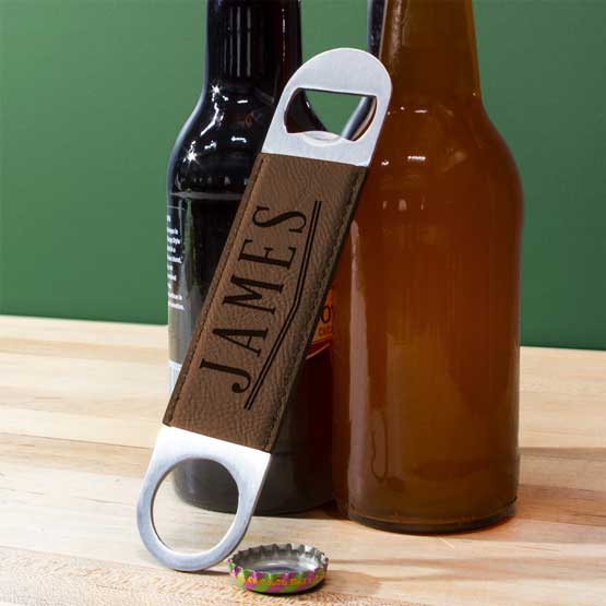 Custom Stainless Steel And Dark Brown Faux Leather Bottle Opener Engraved With James Leaning Against Beer Bottles