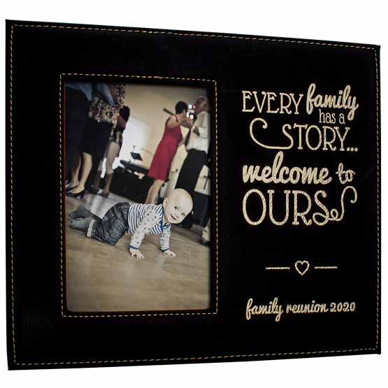 Black And Gold Faux Leather Picture Frame With Photo Of Baby Playing And Engraved With Welcome To Our Family Story Message