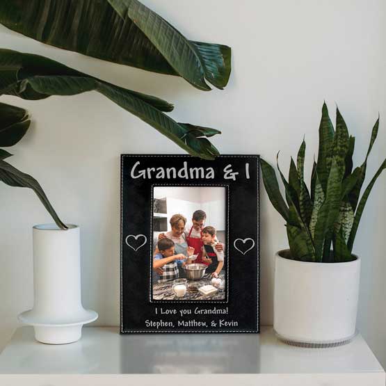 Custom Black Faux Leather Picture Frame With Laser Engraved Grandma And I Text And Family Photo On Shelf With Plants