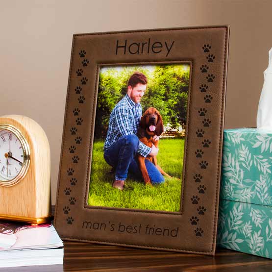 Dark Brown Faux Leather Picture Frame With Photo Of Man And Dog And Engraved With Name And Man’s Best Friend On A Dresser