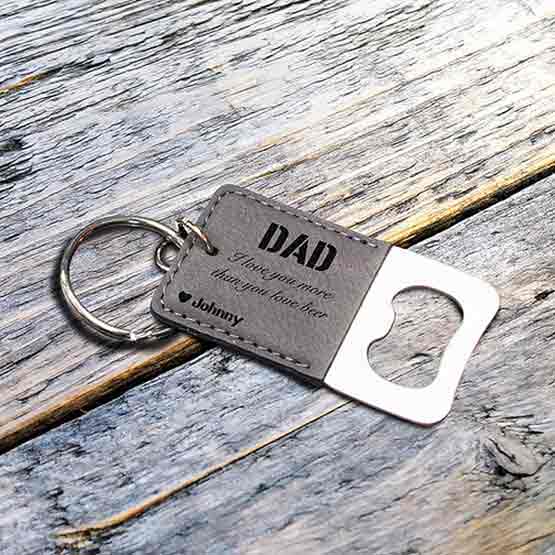 Small Custom Gray Faux Leather Keychain Bottle Opener Engraved With Name And Funny Message For Dad On Picnic Table