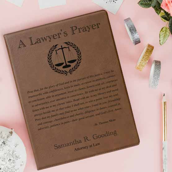 Custom Dark Brown Faux Leather Notebook Engraved With Name And Justice Logo And Complete Lawyer’s Prayer On Pink Table