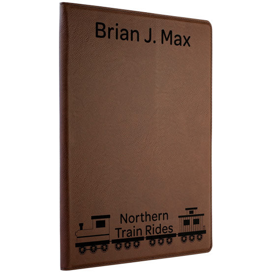 Custom Dark Brown Faux Leather Notebook Laser Engraved With Name And Northern Train Rides Logo Against A White Background