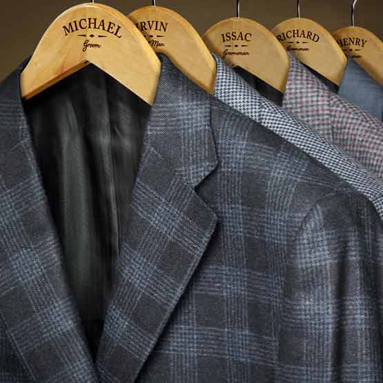 Row Of Suits On Custom Maple Wood Clothes Hangers Laser Engraved With Names And Groom Text Hanging Via Closet Rod