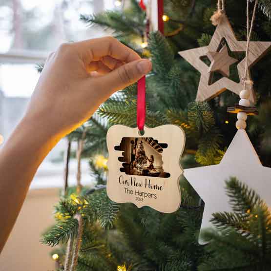 Hand Hanging Ornate Maple Wood Ornament With Printing Of Family Christmas Photo And New Home Details Onto A Christmas Tree