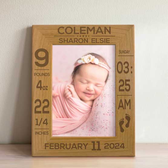 Custom Red Alder Picture Frame With Baby Girl Photo And Laser Engraved With Newborn Details Standing On Wood Shelf Via Easel