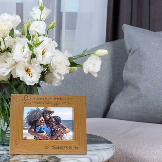 Red Alder Picture Frame With Family Photo And Engraved With Names And Funny Message For Dad On Coffee Table With Flowers