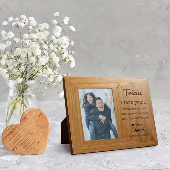 Red Alder Picture Frame With Couple Photo And Engraved With Names And Date And I Love You Message On Table With Flowers