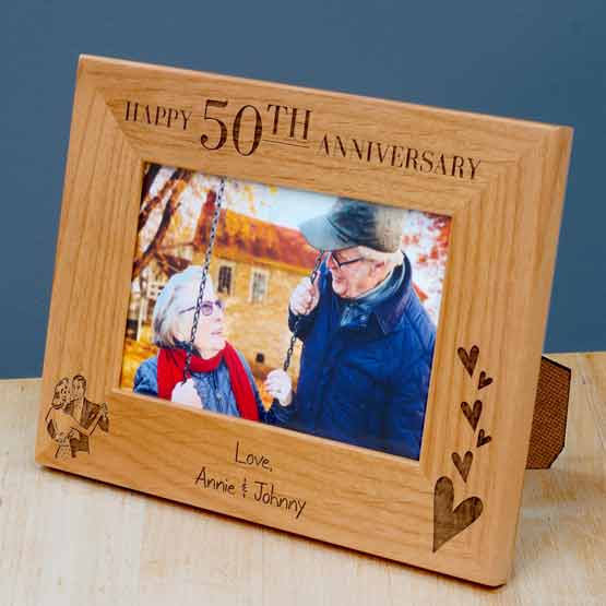 Custom Red Alder Picture Frame With Photo Of Old Couple And Engraved With Anniversary Message And Names Standing On Dresser