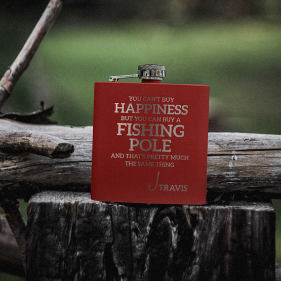 Custom Red Powder Coated Stainless Steel Flask Engraved With Fishing Pole Happiness Message And Name On Log Outdoors