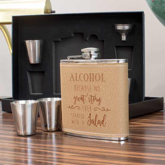 Leather Wrapped Stainless Steel Flask With Funny Alcohol Message On Wood Shelf With Black Presentation Box And Shot Glasses