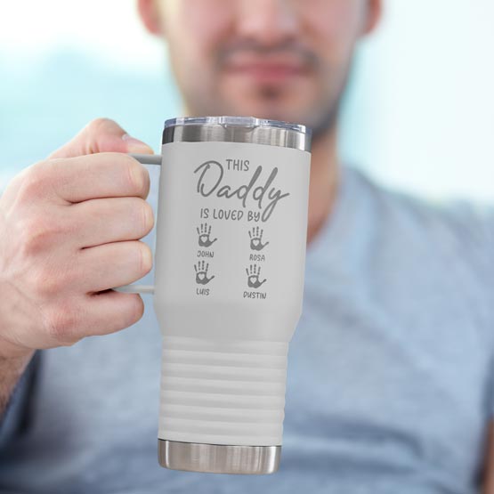 Man Holding White 20 Ounce Tumbler With Handle And Engraved With This Daddy Is Loved By And Kids Names And Handprints Art