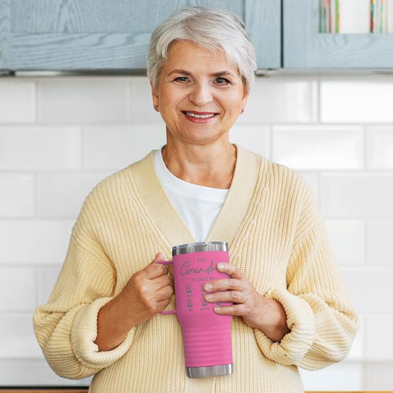 Old Woman Holding Pink 20 Ounce Tumbler With Handle And Engraved With This Grandma Is Loved By And Kids Names And Handprints