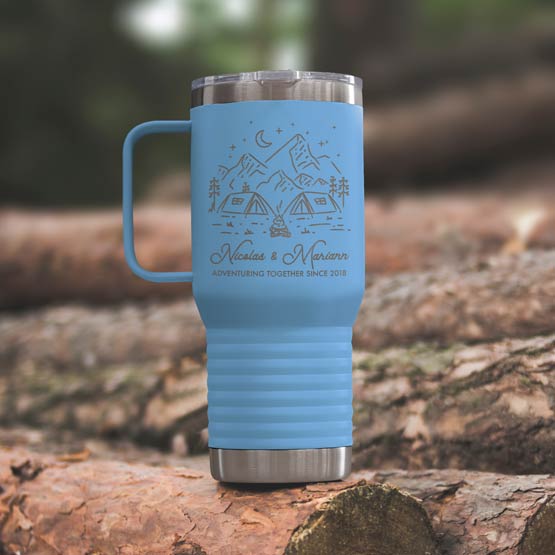Light Blue Stainless Steel Coffee Tumbler With Handle And Engraving Of Camping Art And Names And Date On Wood Log Outdoors