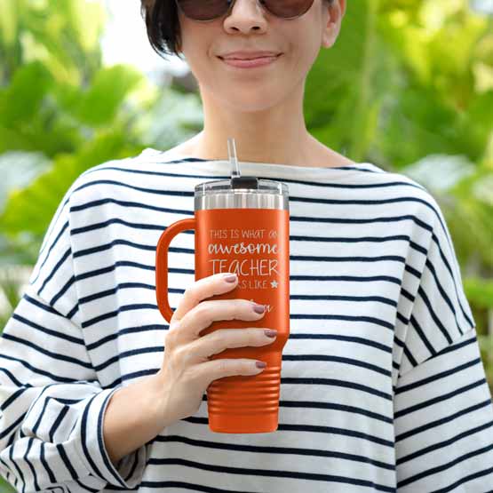 Happy Woman Outdoors Holding Custom Orange Stainless Steel Coffee Tumbler With Handle And Straw And Teacher Message