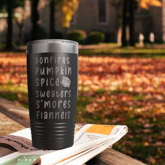 Custom Black Stainless Steel Coffee Tumbler Laser Engraved With Smore Art And Fall Themed Terms Outdoors On Wood Bench
