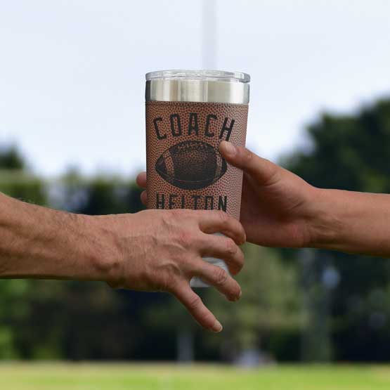 Men Hands Exchanging Faux Leather Wrapped Coffee Tumbler With Football Theme And Engraved With Coach Helton And Football Art