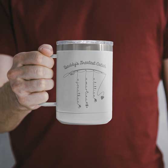 Man Holding White 15 Ounce Tumbler Mug Laser Engraved With Daddy’s Greatest Catch And Fishing Rod Art With Kids Names