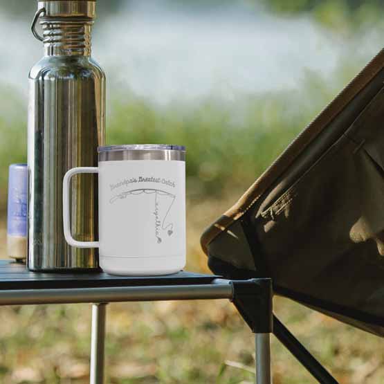 White 15 Ounce Tumbler Mug Engraved With Daddy’s Greatest Catch And Fishing Rod With Names On Table Outdoors With Thermos