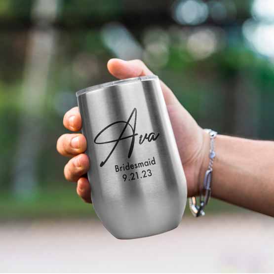 Woman Hand Outdoors Holding Custom Silver Stemless Wine Tumbler Engraved With Name And Date And Bridesmaid Text