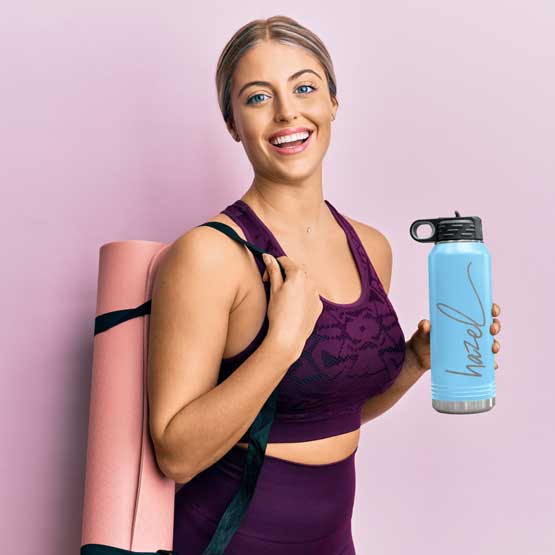 Woman In Workout Clothes Carrying Yoga Mat And Light Blue Thirty Two Ounce Water Bottle With Straw And Engraved Name