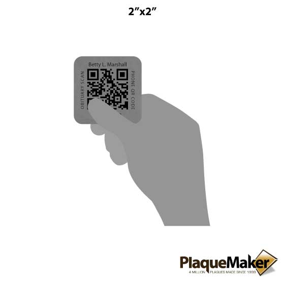 Size Guide Comparing The Size Of A Memorial QR Code Tag To An Average Person's Hand.