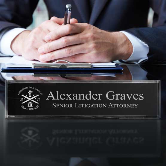 Hands On Office Desk With Acrylic Name Plate Featuring Black Backing Engraved With Legal Company Logo And Employee Details