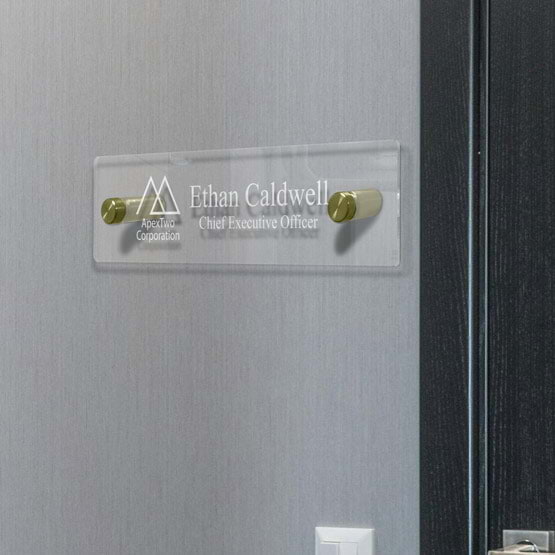 Clear Acrylic Office Name Plate Printed With Logo And Business CEO Details Mounted On Office Wall Via Two Gold Standoffs