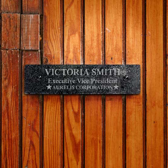 Custom Granite Office Plate Engraved With Employee Details And Company Name Mounted Onto Wood Wall Via Two Black Standoffs