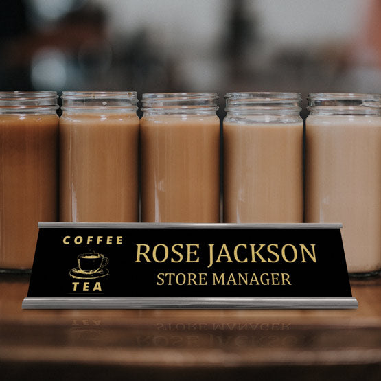 Laser Engraved Aluminum Desk Name Plate With Silver Bracket On Desk With Coffee.