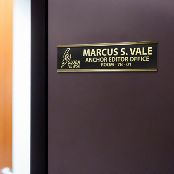 Black Metal Office Plate With Gold Engravings Of Custom Logo And Office Details Mounted Beside Door Via Gold Bracket