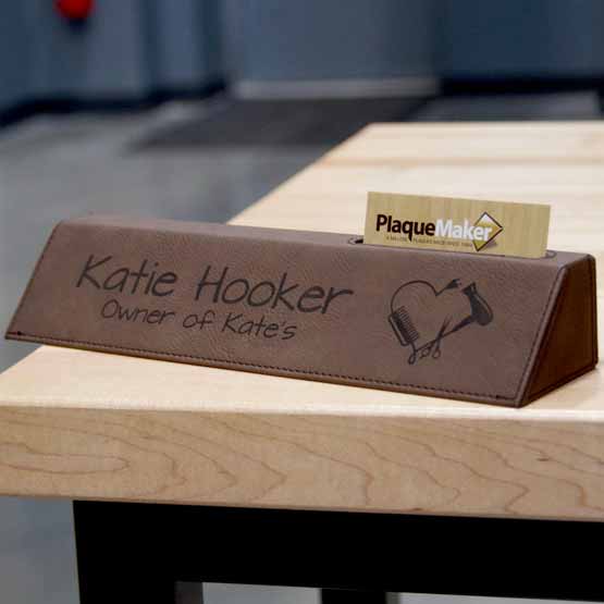 Dark Brown Faux Leather Desk Wedge With Card Slot And Engraved With Logo And Owner Details On Wood Office Desk