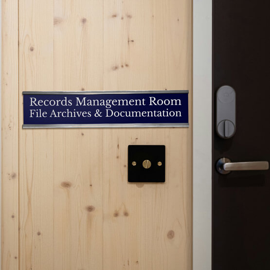 Blue Plastic Office Name Plate Engraved With Records Room Details Mounted Onto Wood Wall Beside Door Via Silver Bracket
