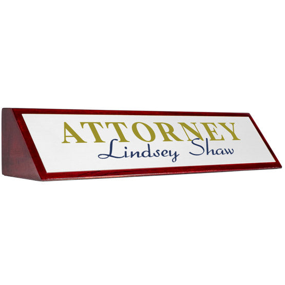 Rosewood Desk Wedge With Aluminum Plate Printed With Attorney Lindsey Shaw In Gold And Blue Against A White Background