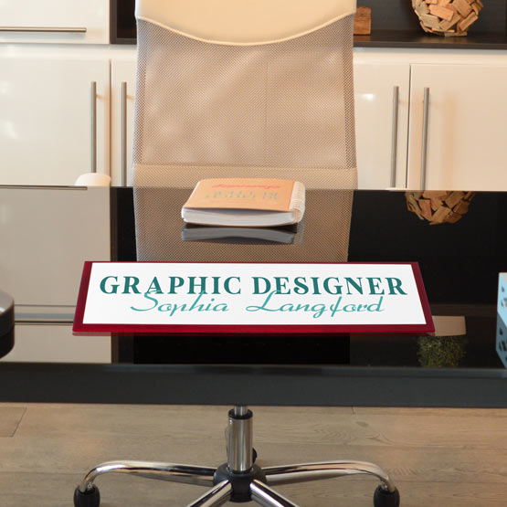 Office chair with a nameplate labeled 'Graphic Designer Sophia Langford' in a home office setting.