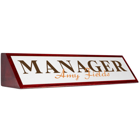 Rosewood Desk Wedge With Aluminum Plate Printed With Manager Amy Fields In Brown And Orange Against A White Background