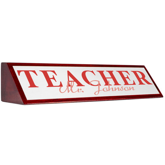 Rosewood Desk Wedge With White Aluminum Plate Printed With Teacher Mister Johnson In Red Against A White Background