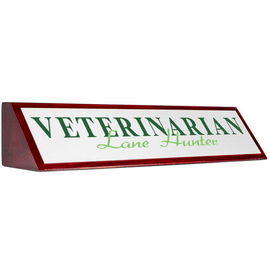 Rosewood Desk Wedge With White Aluminum Plate Printed With Veterinarian Lane Hunter In Green Against A White Background