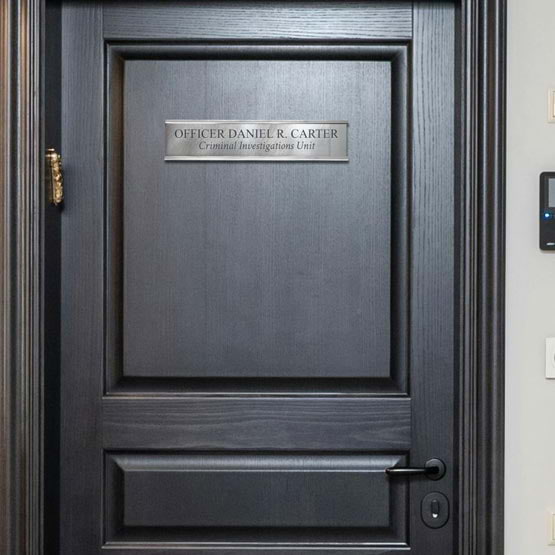 Titanium Office Plate Laser Fused With Custom Officer And Unit Details Mounted Onto Black Door Via Silver Bracket