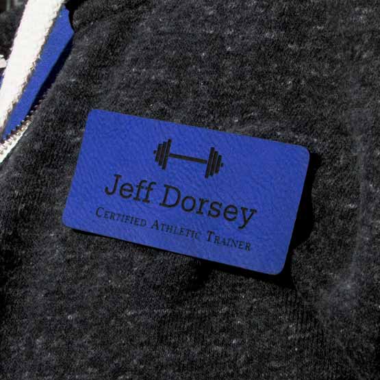 Custom Faux Leather Blue Name Tag For Athletic Trainer On Gray Workout Jacket.
