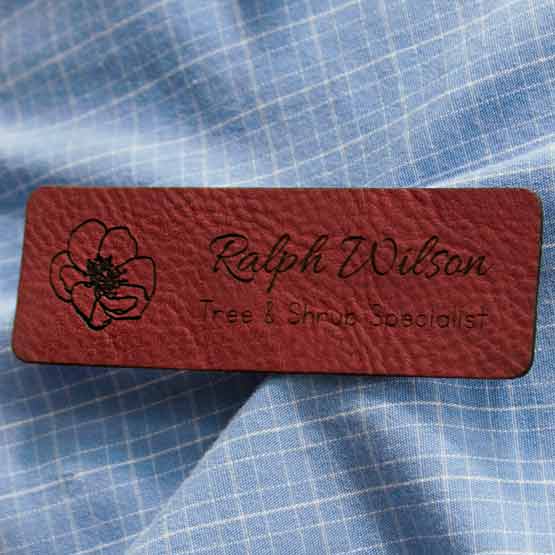 Rose Faux Leather Name Tag With Logo And Title On Blue Dress Shirt.