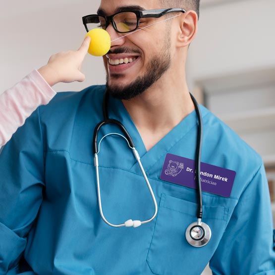 Pediatrician Wearing Purple Custom Plastic Medical Name Tag While Wearing Silly Nose For Kid. 