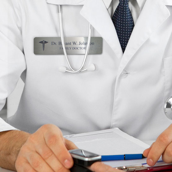Doctor Wearing Custom Engraved Stainless Steel Medical Name Badge While Taking Patient's Heart Rate. 