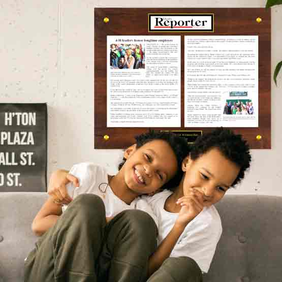 Custom Newspaper Plaque In Full Color With Personalized Plate Over Couch With Boys.