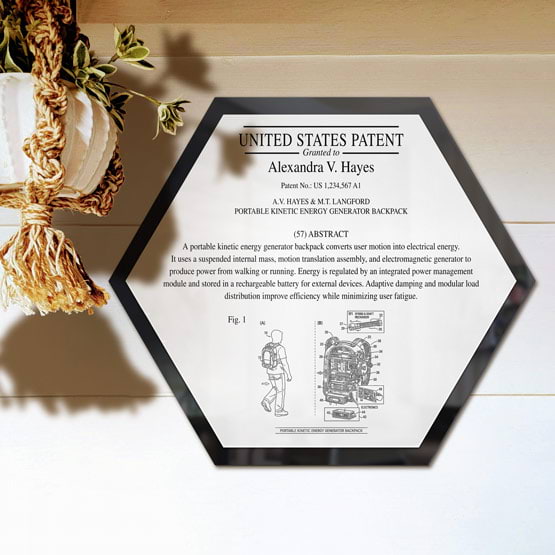 Honeycomb Patent Plaque With Black Acrylic Board And White Plate Printed With Sample Details Mounted Onto Wall Near Plant