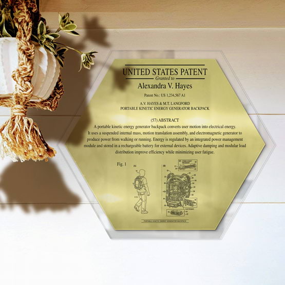 Honeycomb Patent Plaque With Clear Acrylic Board And Gold Plate Printed With Sample Details Mounted Onto Wall Near Plant