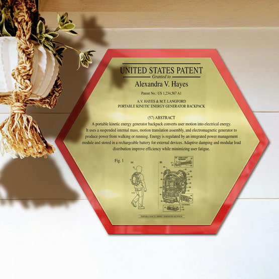 Honeycomb Patent Plaque With Red Acrylic Board And Gold Plate Printed With Sample Details Mounted Onto Wall Near Plant