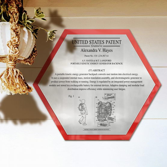 Honeycomb Patent Plaque With Red Acrylic Board And Silver Plate Printed With Sample Details Mounted Onto Wall Near Plant